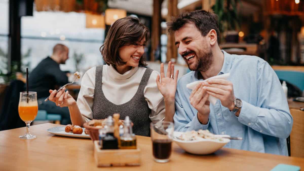 Couple enjoying food at a restaurant.