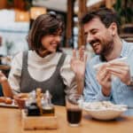 Couple enjoying food at a restaurant.