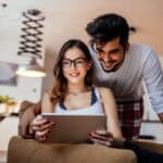 Couple using their digital tablet together.