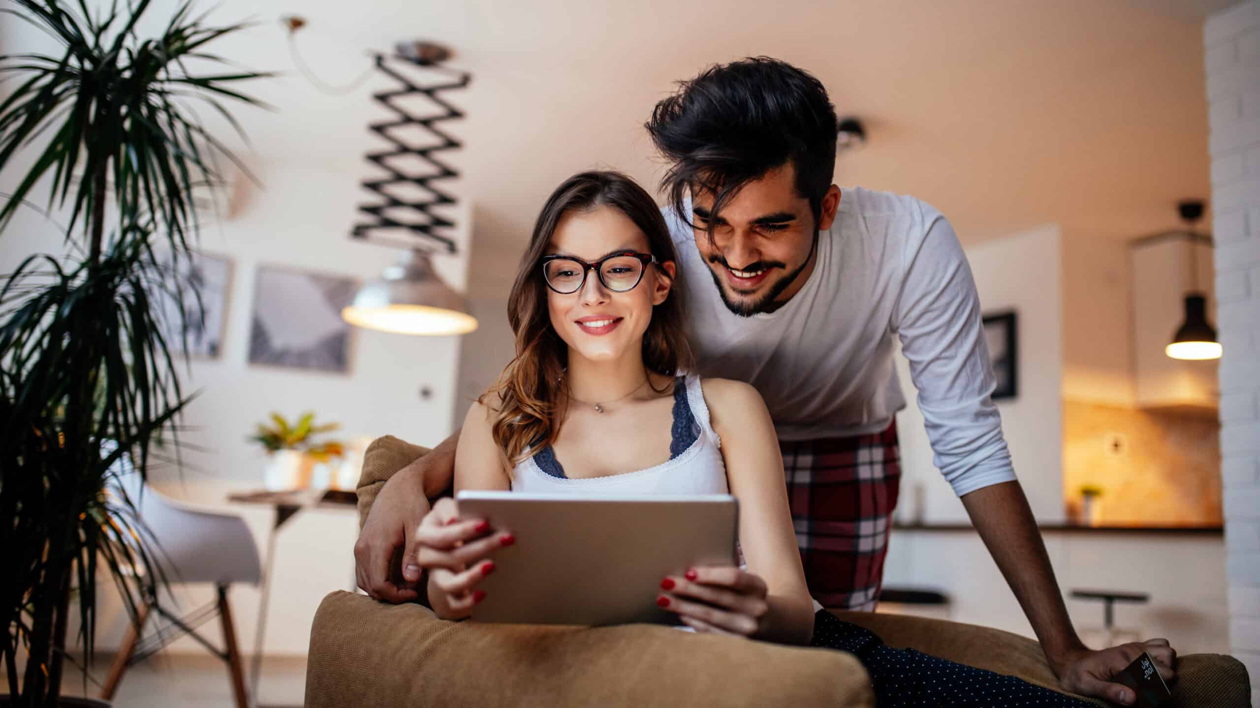 Couple using their digital tablet together.