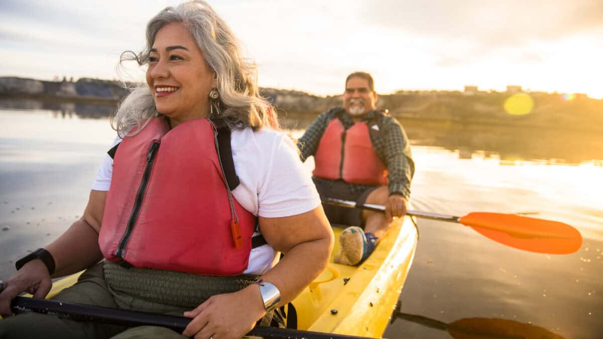 Happy couple kayaking together.
