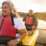 Happy couple kayaking together.