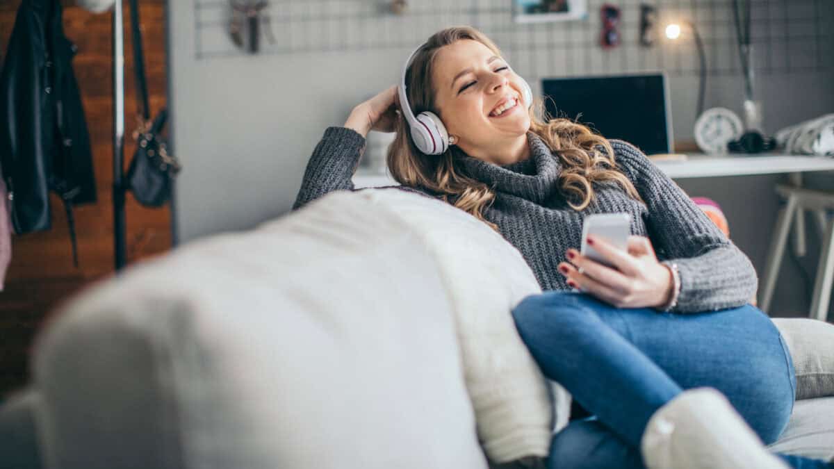 Woman enjoying listening to music on her headphones.