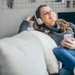 Woman enjoying listening to music on her headphones.