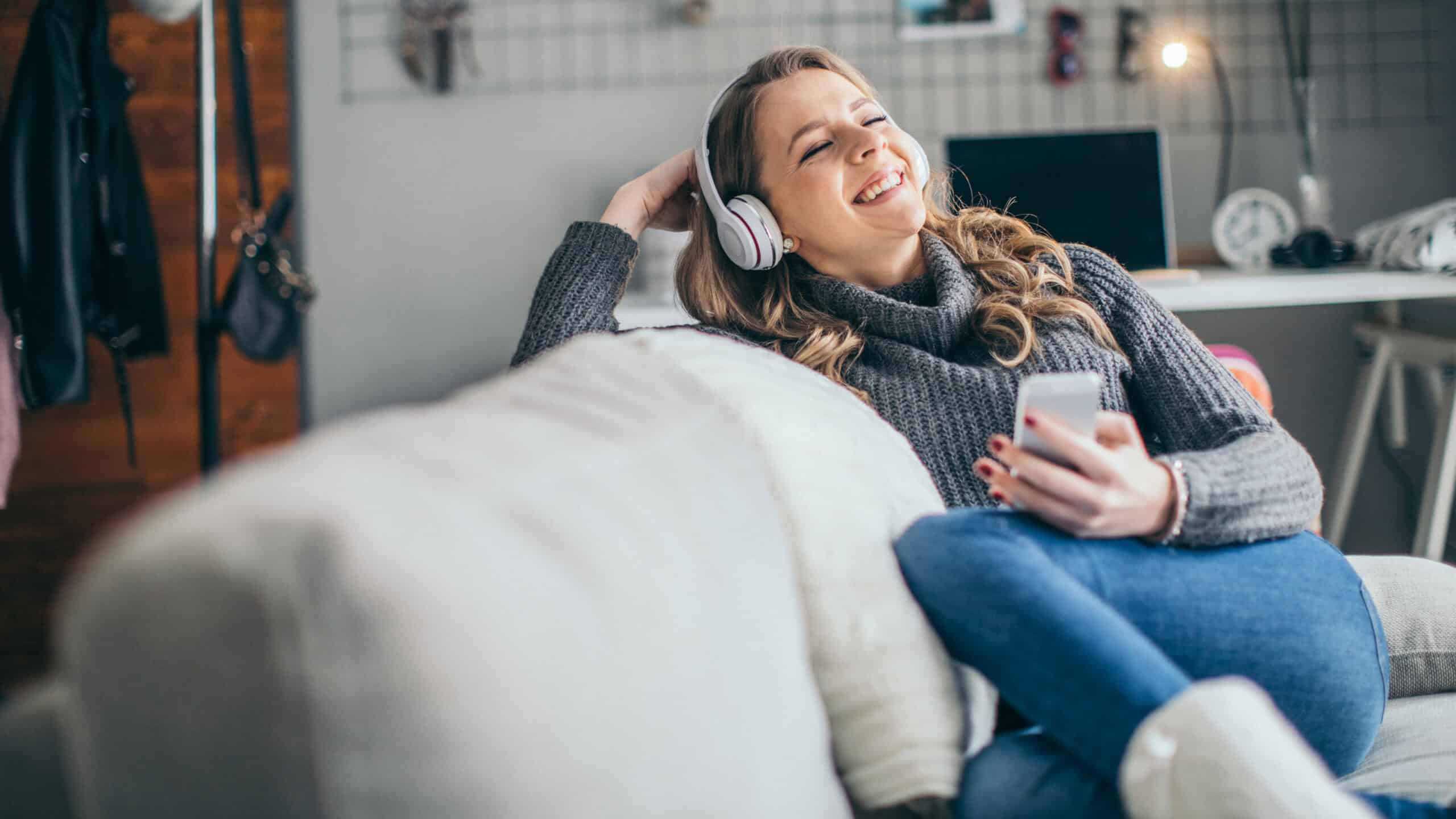 Woman enjoying listening to music on her headphones.