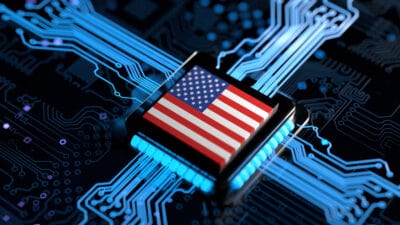 Processor chip on circuit board with USA flag.