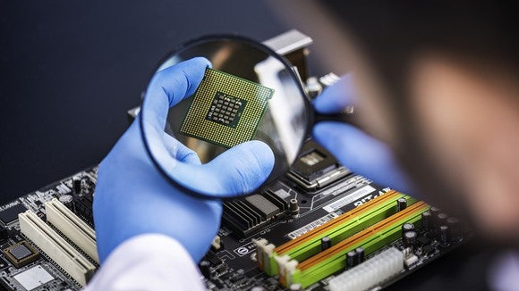 Magnifying glass on semiconductor chip.