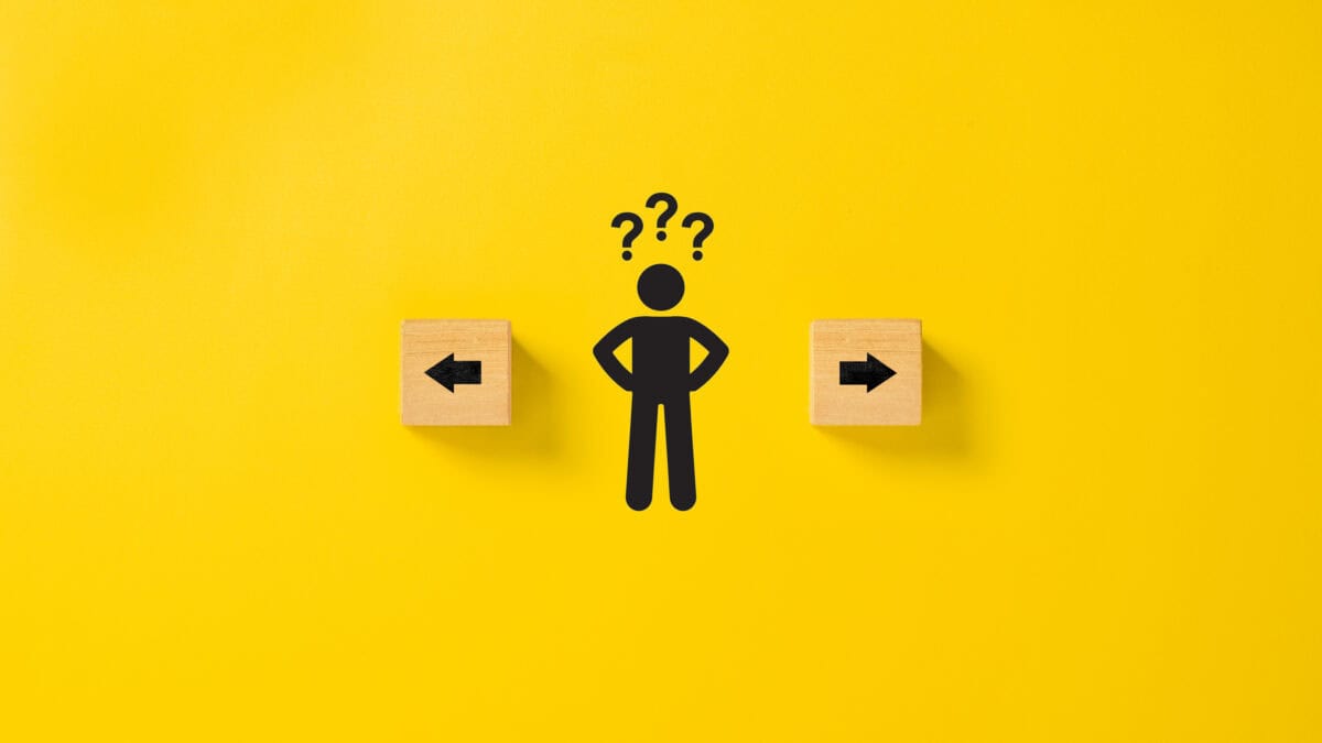 Diagram of black male figure with question marks on top and arrows on wooden blocks on each side.
