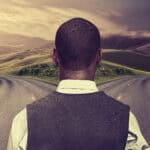 Man looking at two roads going in different directions.
