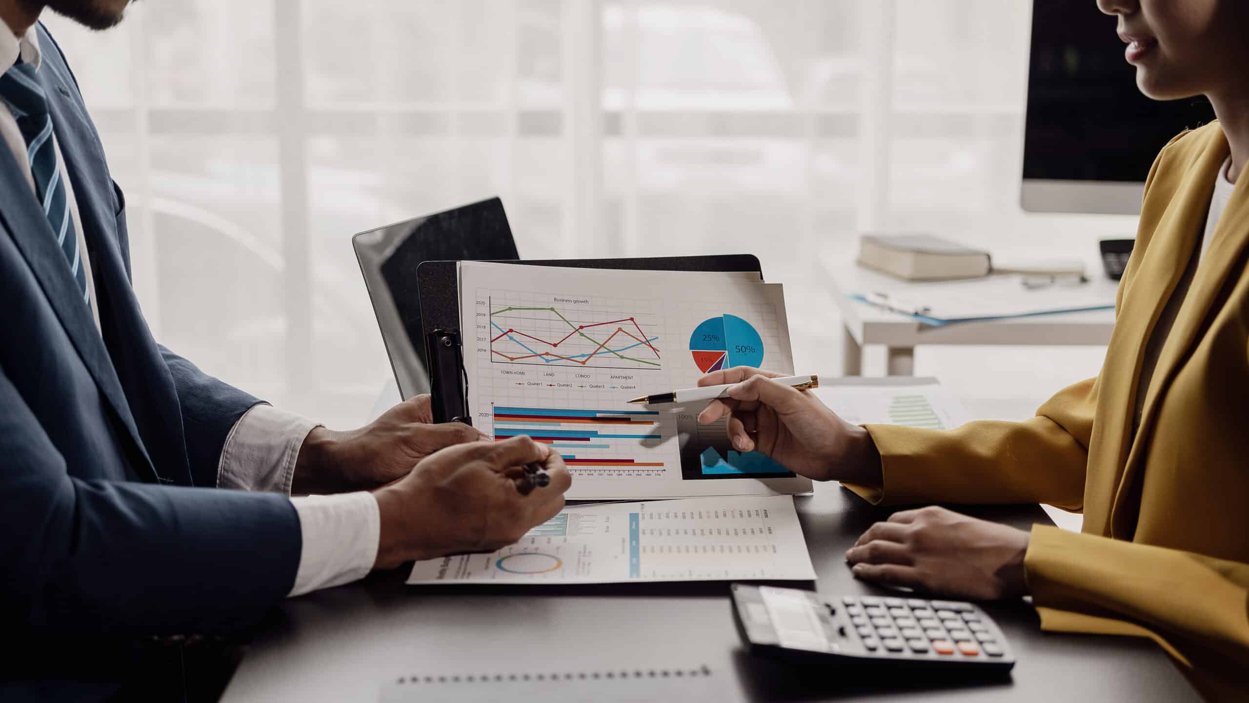 Two business partner colleagues discuss financial and company results.