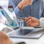 Two colleagues working with company financial results.