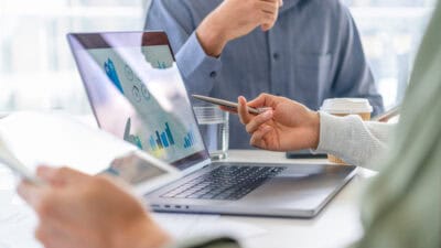 Two colleagues working with company financial results.