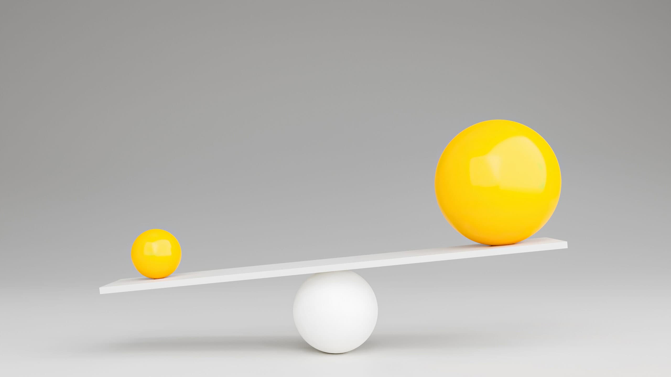 One large yellow sphere on one side of a white seesaw, with a small yellow sphere on the other side.