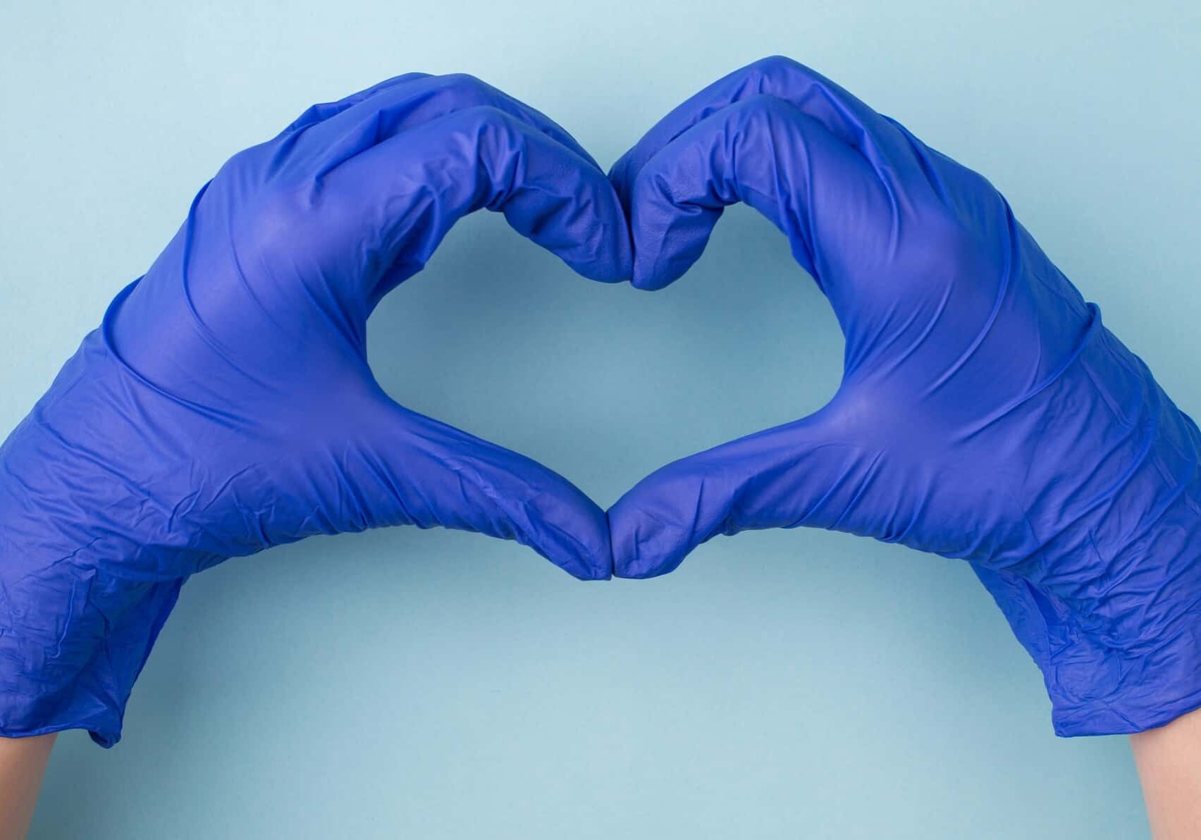 two hands wearing medical gloves make the shape of a heart, indicating the best healthcare shares on the ASX market